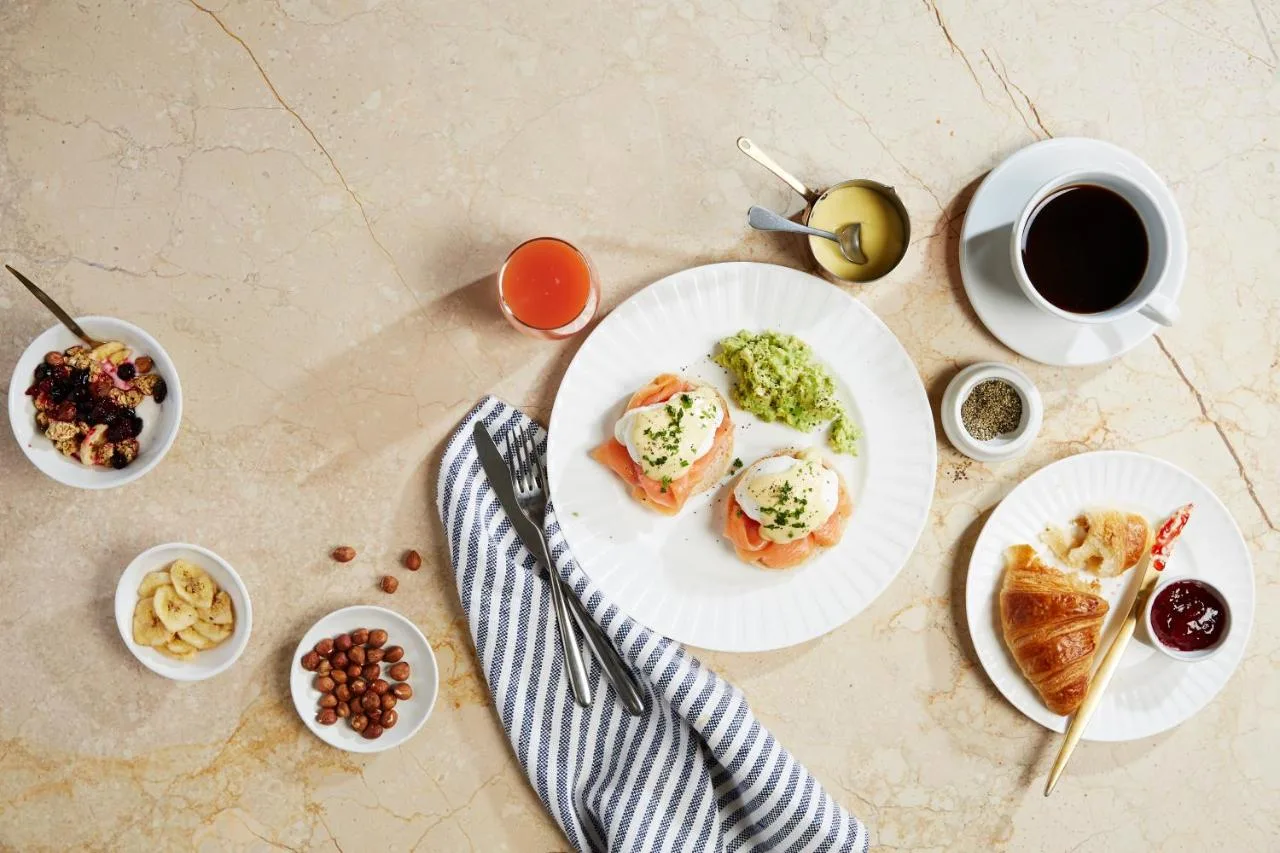 A table with plates of food and a cup of coffee at Cardiff Marriott Hotel in Cardiff